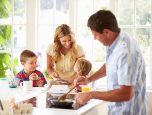 Father Preparing Family Breakfast In Kitchen